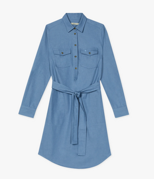 The RM Williams Adare Dress is a light blue chambray shirt dress with long sleeves, collar, button-down front, two chest pockets, tie waistbelt, and a slightly curved hem for a modern look.