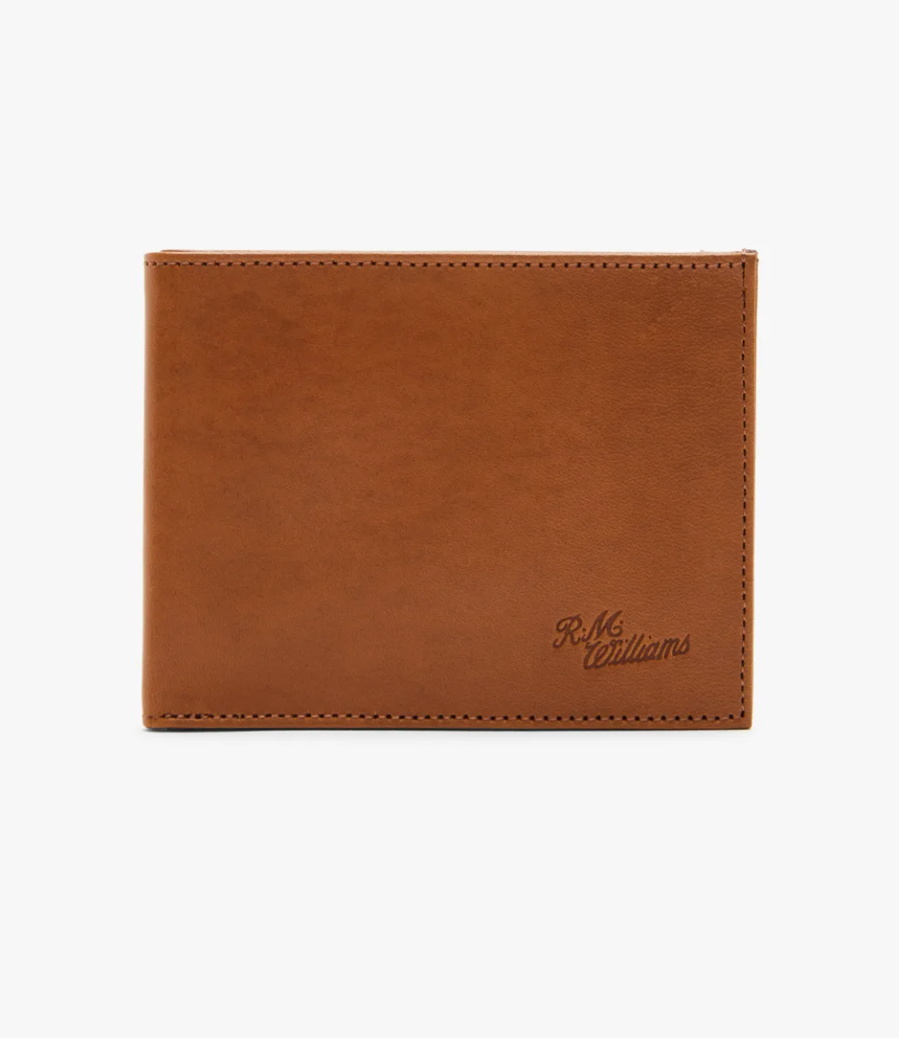 The RM Williams Singleton Bi-fold Wallet features a brown calf leather design with clean edge stitching, embossed "R.M." and "williams" in the corner. It offers RFID protection and is shown closed against a plain white background.