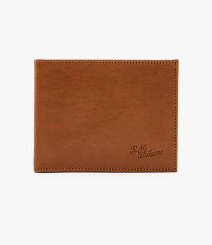 The RM Williams Singleton Bi-fold Wallet features a brown calf leather design with clean edge stitching, embossed "R.M." and "williams" in the corner. It offers RFID protection and is shown closed against a plain white background.