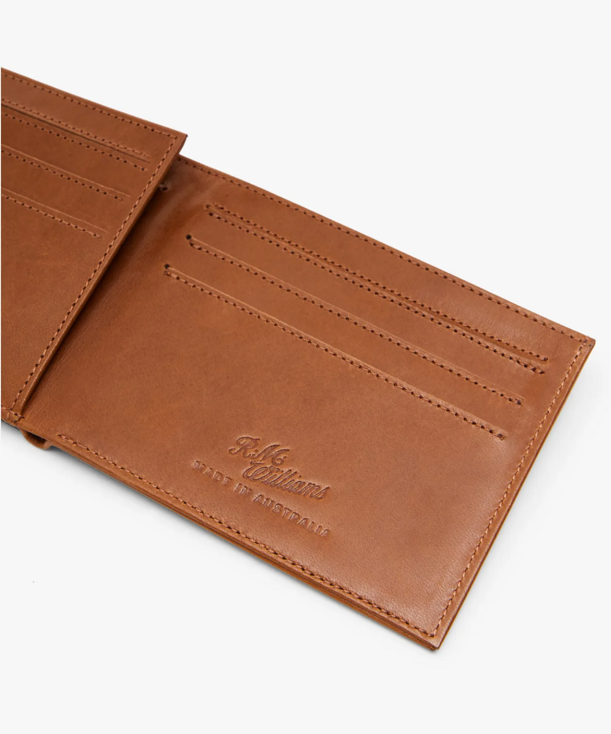 The RM Williams Singleton Bi-fold Wallet is made from open brown calf leather, offering RFID protection and multiple card slots. It features brand embossing with "MADE IN AUSTRALIA" on a plain white background.