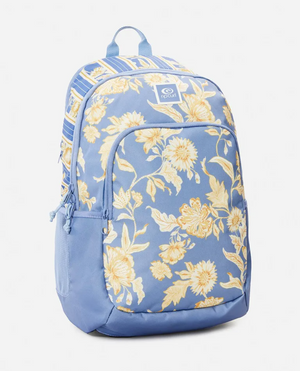 The Rip Curl Ozone 2.0 30L Backpack combines style and sustainability with its blue design featuring yellow floral patterns, white top stripes, recycled polyester material, two main compartments, and a small front pocket logo.