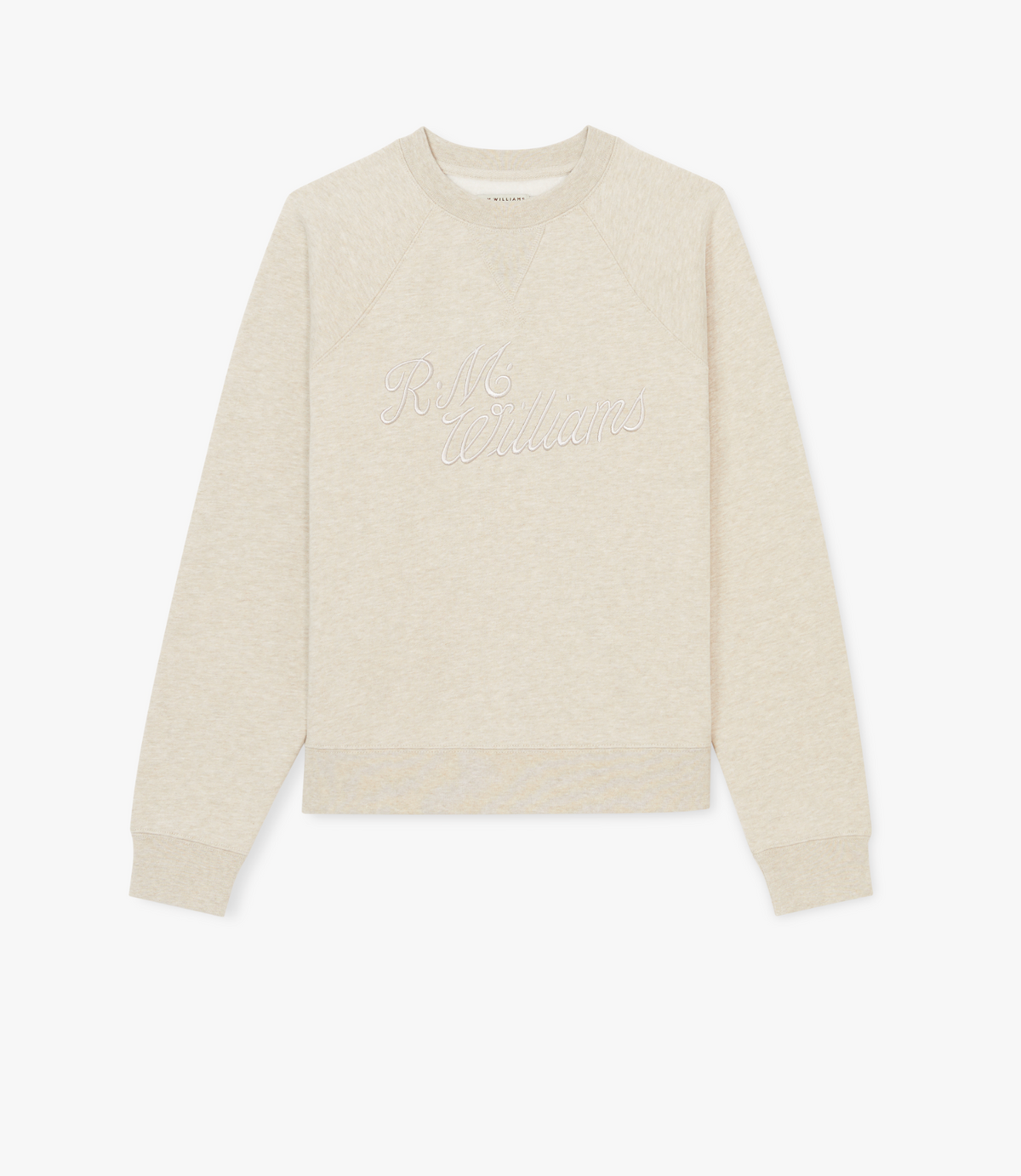 The RM Williams Womens Script Crew is a light beige sweatshirt in brushed cotton fleece with long sleeves, ribbed cuffs, and subtle "R.M. Williams" embroidery across the chest. It’s shown laid flat on a white background.