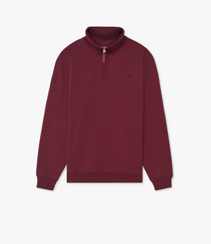 The RM Williams Mulyungarie Fleece is a maroon quarter-zip sweatshirt in brushed cotton fleece with ribbed cuffs and hem, a small embroidered logo on the left chest, and a brown zipper pull tab. Shown against a white background.