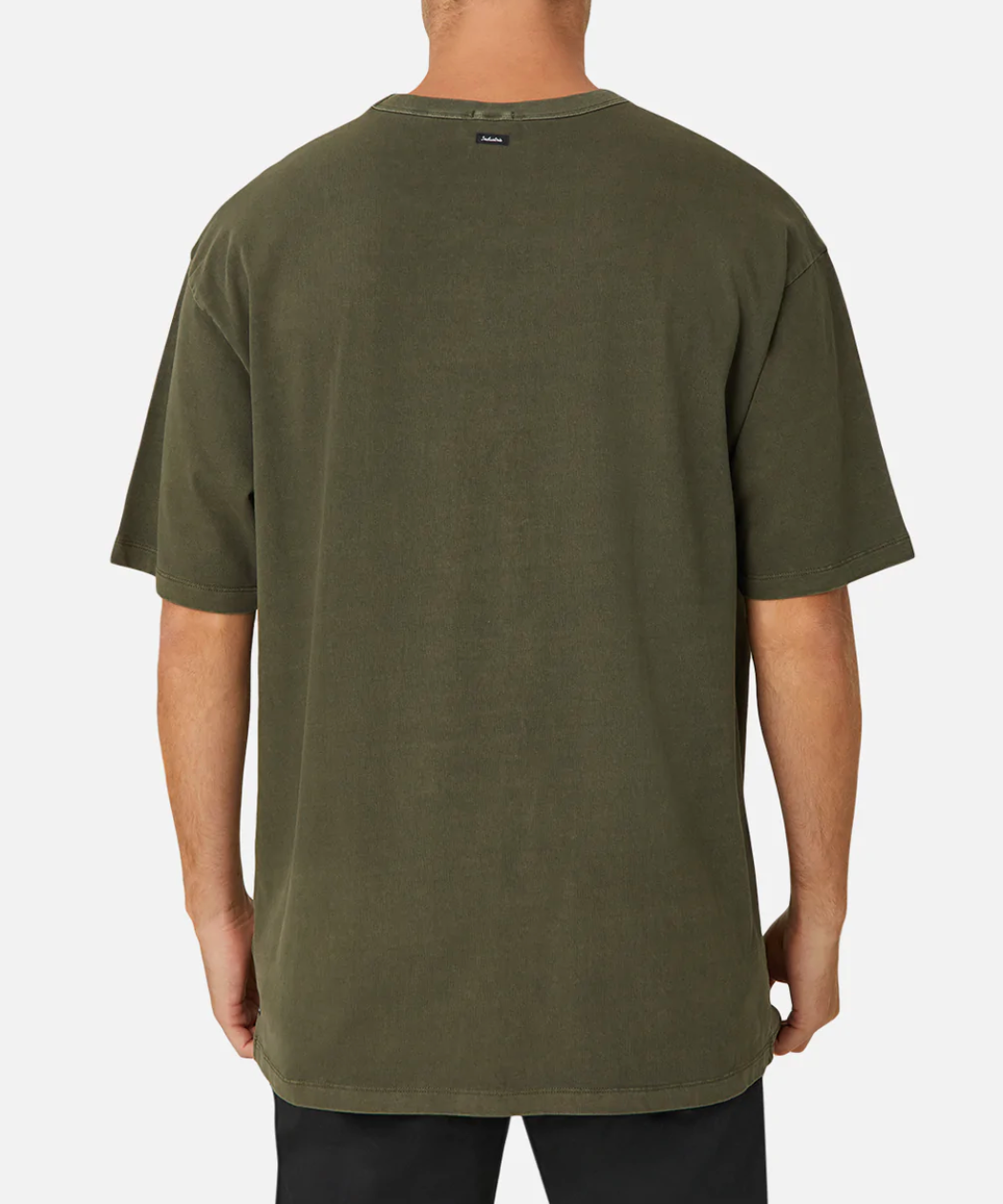 A person is seen from behind wearing the Industrie The Del Sur Tee, an oversized, 100% cotton T-shirt in olive green. It has a small tag near the neckline and is paired with black pants against a plain white background.