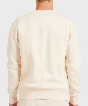 A person is shown from the back against a light gray background, wearing the Academy Brand Crew Sweat in cream with matching relaxed fit brushed fleece pants.