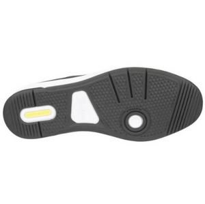 The image displays the sole of the Florsheim Crossover Lace Sneaker, featuring a patterned tread with grooves for traction and slip-resistance, circular details near the heel and arch, and a yellow rectangular insert by the heel with text.
