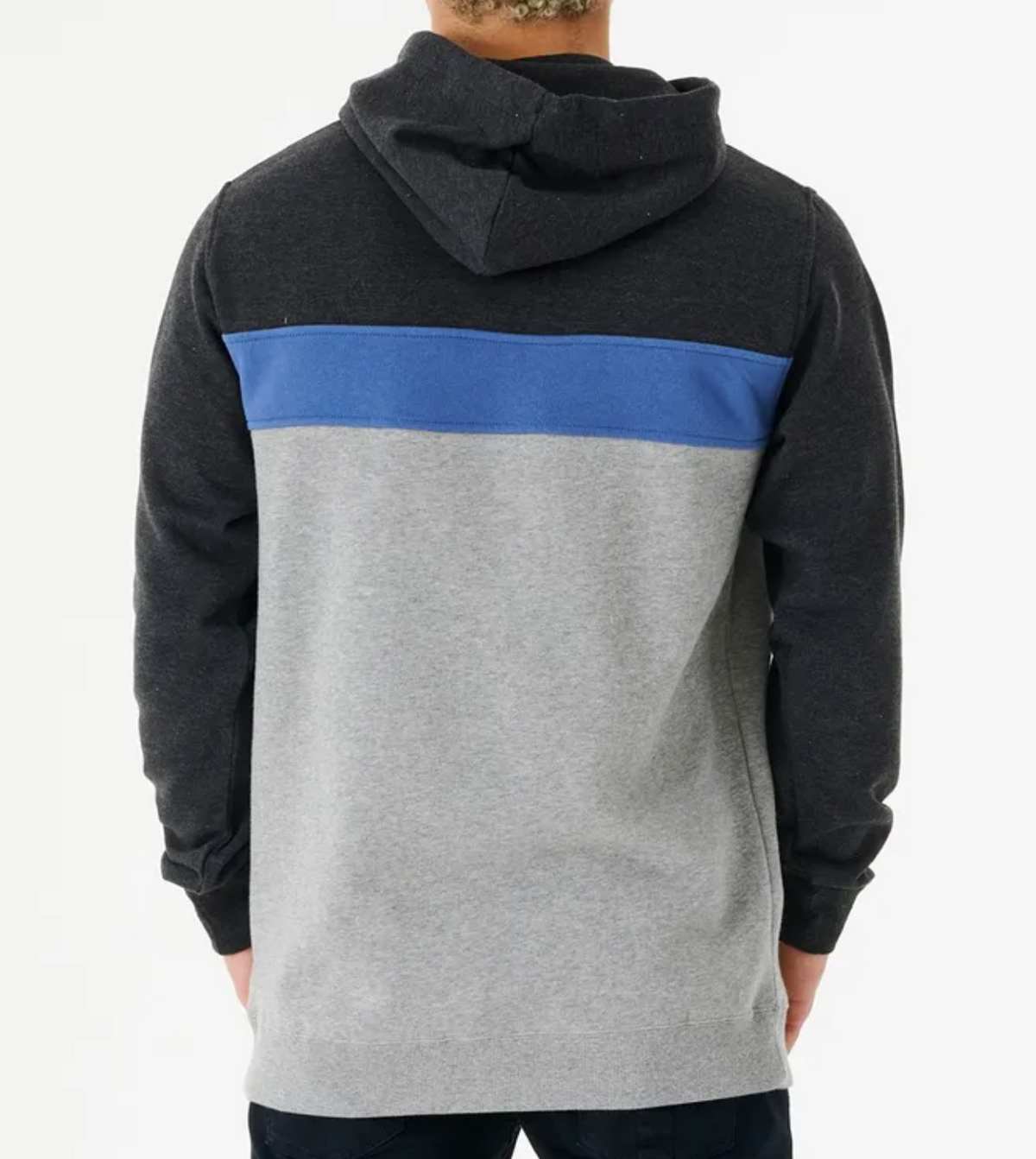 The person wears a Rip Curl Undertow Panel Hood, showcasing black hood and sleeves, a blue stripe on the upper back, and a gray lower section. This comfortable fleece-lined casual hoodie is perfect for staying cozy while facing away from the camera.