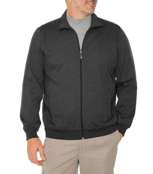A man models the Breakaway Zed Snowy Mt Fleece Full Zip in dark gray over a light gray t-shirt and beige pants, standing against a white backdrop. He casually places his left hand in his pocket, highlighting the jacket's stylish ribbed collar and cuffs.