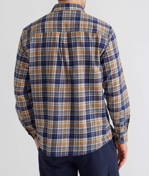 Wearing a Breakaway Ford Cotton Brush Shirt, with its cozy long-sleeve plaid design and shades of blue, brown, and white, a person faces away from the camera. The 100% cotton shirt complements their navy blue pant-pocketed hand against a plain white backdrop.