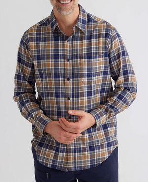 A person dons the Breakaway Ford Cotton Brush Shirt, an easygoing plaid design in blue, brown, and white against a plain white backdrop. This 100% cotton, long-sleeved, button-up shirt has one hand on their waist, combining style with comfort for any casual breakaway moment.
