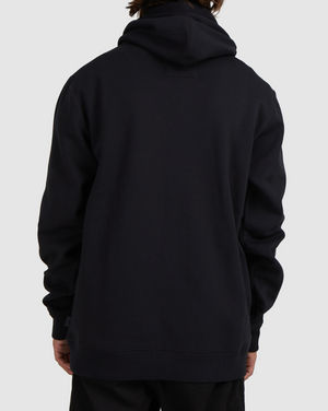 A person is seen from the back wearing a black Billabong Shoreline Pullover with the hood down, standing against a plain light gray background. Their hands rest by their sides, highlighting the pullover’s casual heavyweight style.