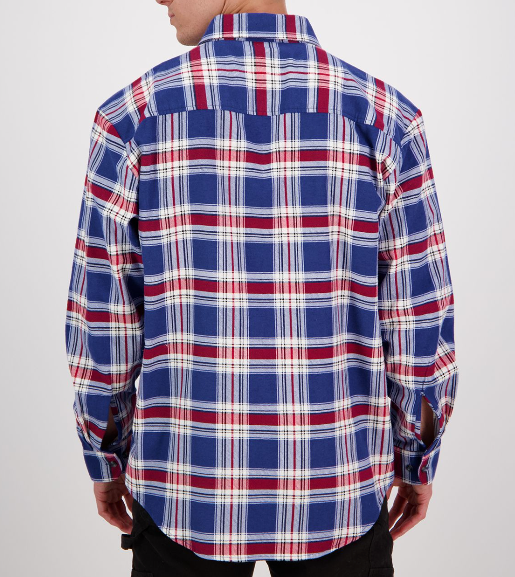 A person with short hair wears a shirt from the Swanndri Egmont Flannelette Twin Pack, featuring a soft brushed cotton plaid pattern in blue, red, and white against a plain background.