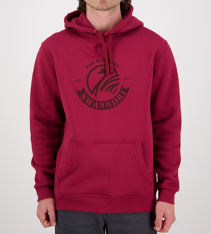 A person in a casual red Swanndri Original Fleece Hoody with a kangaroo pocket and drawstring hood poses against a plain white background, featuring "The Original SwannDri Est. 1913" in a circular logo on the chest.