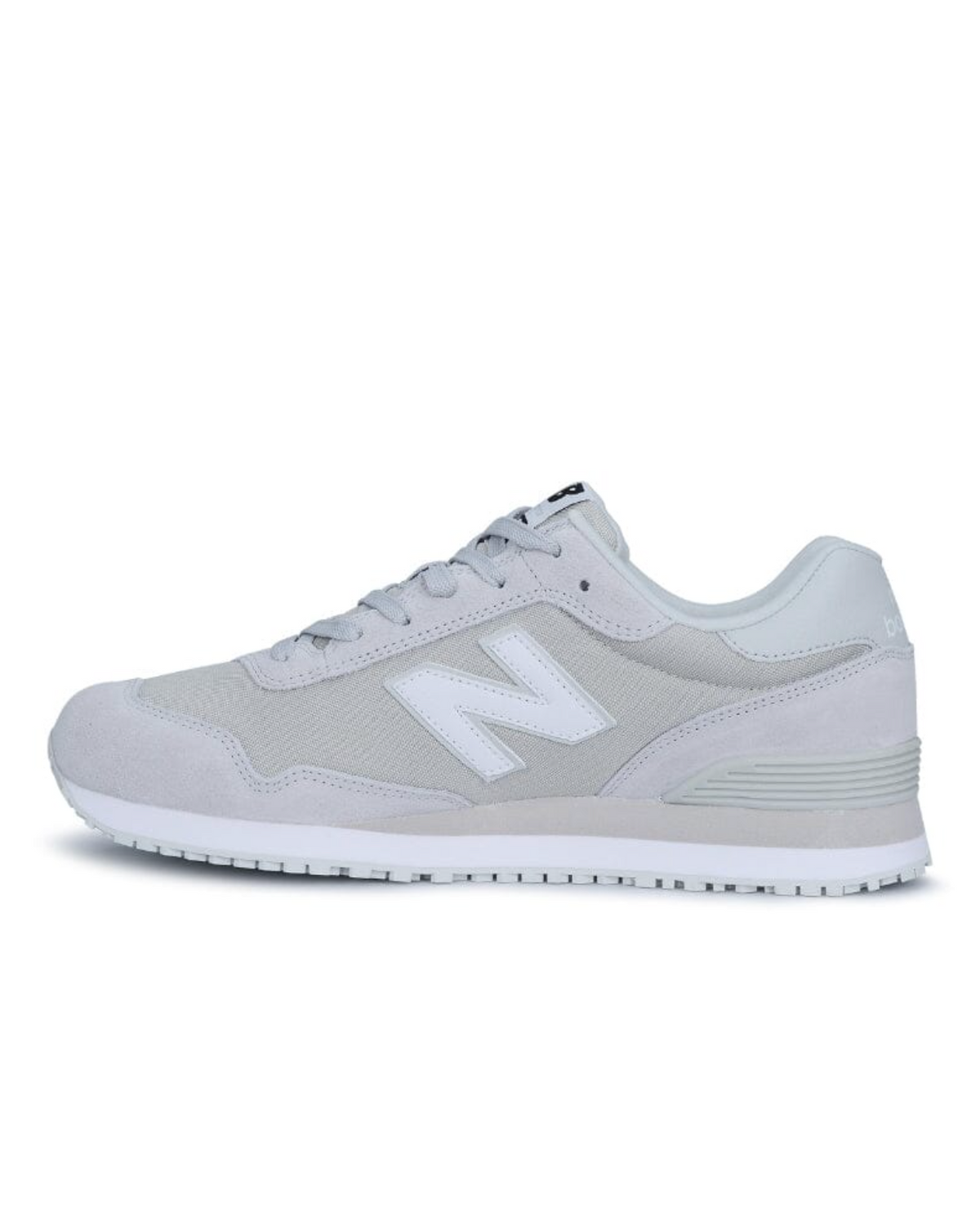 The New Balance 515 SR Shoe features a gray athletic design with a white "N" logo, white sole, and gray laces. Made with suede and mesh, it has a raised heel and lightweight EVA midsole for comfort. A slip-resistant rubber outsole provides stability against a plain white background.