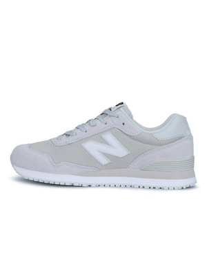 The New Balance 515 SR Shoe features a gray athletic design with a white "N" logo, white sole, and gray laces. Made with suede and mesh, it has a raised heel and lightweight EVA midsole for comfort. A slip-resistant rubber outsole provides stability against a plain white background.