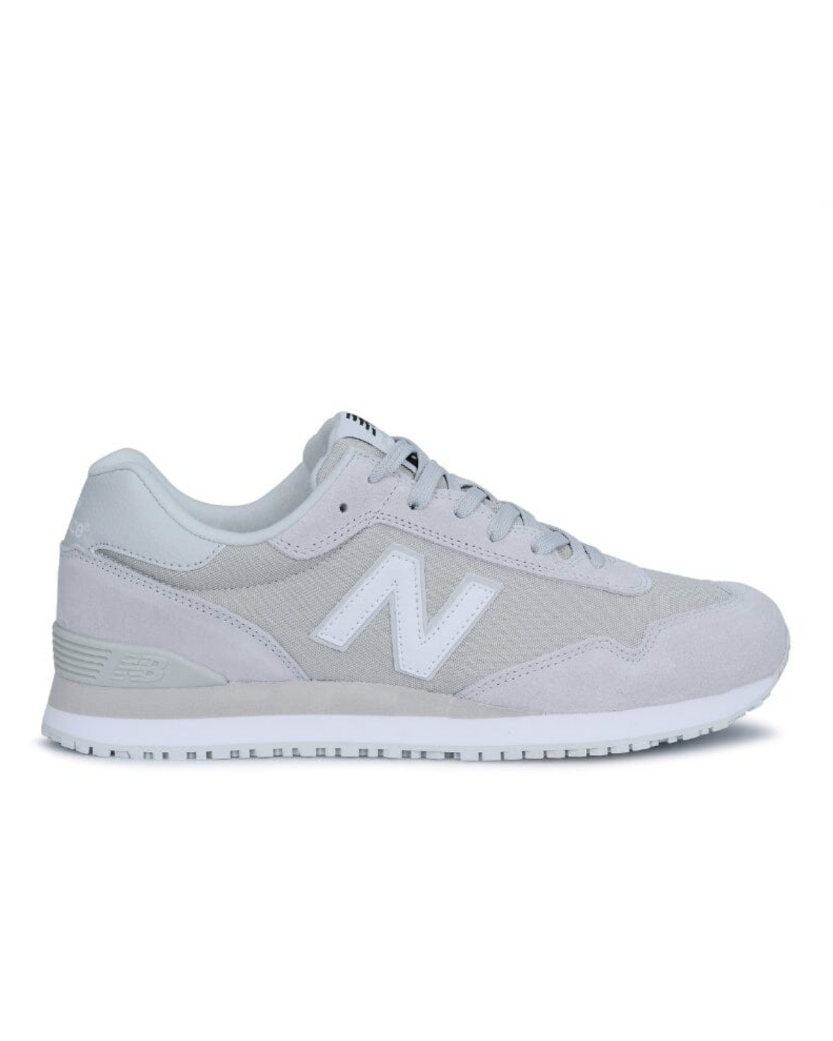 Side view of the New Balance 515 SR Shoe in gray and white, featuring a suede and mesh combo with a prominent "N" logo, flat white sole, and laces. The sleek design includes a slip-resistant rubber outsole for stability, combining style with functionality.
