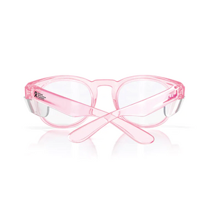 The SafeStyle Cruisers offer transparent pink frames with clear lenses, featuring a breast cancer awareness ribbon and logo on the temples. They provide UV protection and have uniquely styled crossed earpieces to shield your eyes while making a statement.