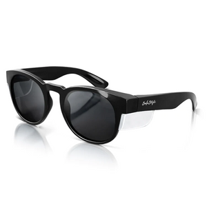 SafeStyle Cruisers boast black polarized round lenses with side shields for UV protection. The glossy frame is sturdy, features a signature logo on the temples, and has excellent safety ratings. The side view highlights its sleek and functional design.