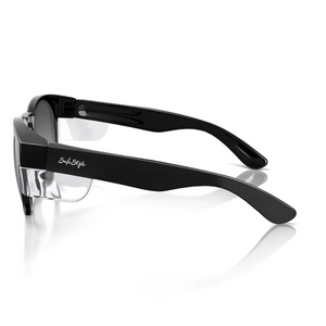 Side view of SafeStyle Cruisers: black thick-frame glasses with a clear nose bridge and UV-protected, slightly angled tinted lenses. A small temple logo complements the glossy finish, highlighting their modern style.