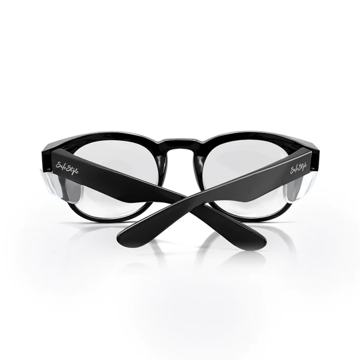 A pair of SafeStyle Cruisers Black Frame Clear Lens safety glasses with crossed arms, clear UV-protective lenses, and branding on both temples, displayed against a white background.