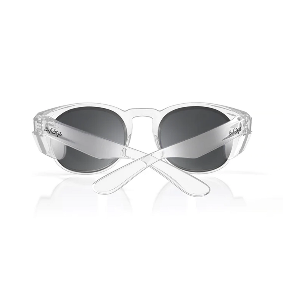 The SafeStyle Cruisers Clear Frame Polarised Lens sunglasses are depicted with clear, transparent frames and dark, oval polarised lenses. The temples intersect at the back, featuring a small logo near the lenses on each side. These sunglasses provide UV protection and are displayed against a white background.