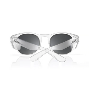 The SafeStyle Cruisers Clear Frame Polarised Lens sunglasses are depicted with clear, transparent frames and dark, oval polarised lenses. The temples intersect at the back, featuring a small logo near the lenses on each side. These sunglasses provide UV protection and are displayed against a white background.
