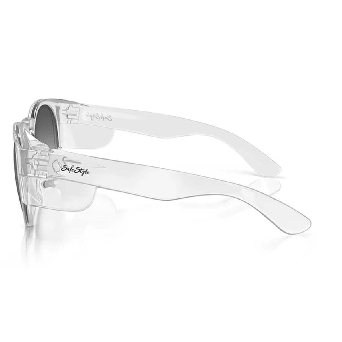 The SafeStyle Cruisers Clear Frame Polarised Lens safety glasses boast sleek, clear plastic frames and arms, with the word "Style" inscribed on one arm. Featuring polarised lenses for enhanced clarity and UV protection, these glasses are positioned horizontally on a white background, showcasing their modern design.
