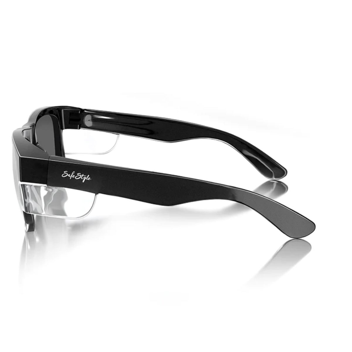 Featuring the SafeStyle Fusions, these black wraparound sunglasses have glossy rectangular frames, transparent nose pads, and polarized lenses for UV protection. The temple arms display subtle white branding, and shield-like lenses ensure superior safety ratings.
