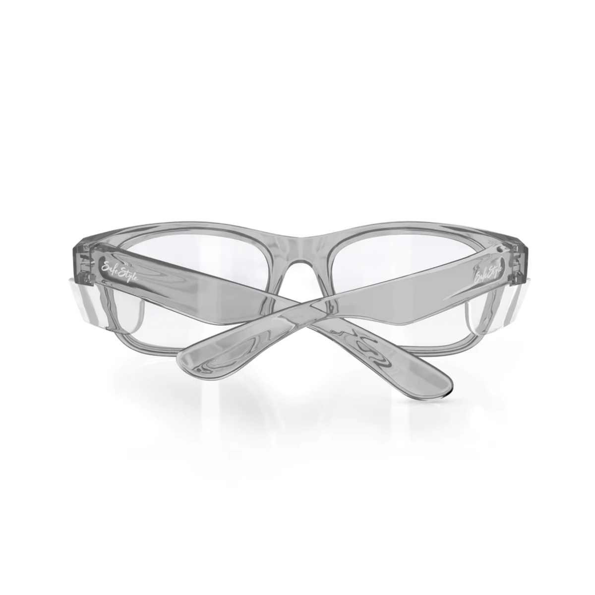 The SafeStyle Classics are clear safety glasses featuring rectangular polycarbonate frames and transparent lenses. The left temple displays the brand in black script, and the sturdy, slightly curved graphite frame ensures a snug fit while providing UV protection.