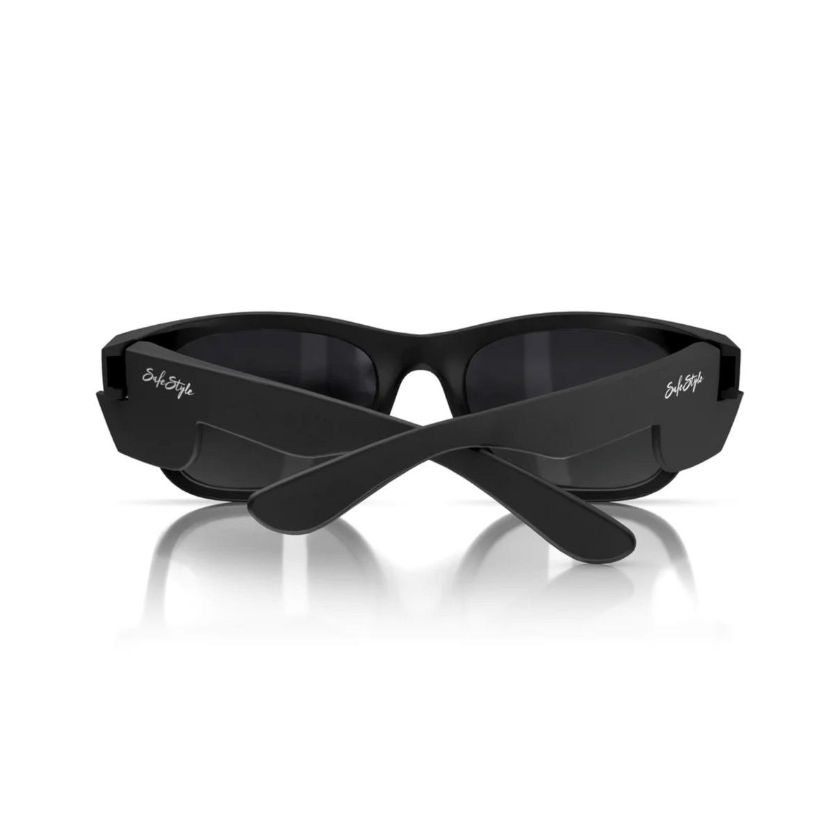 The SafeStyle Classics feature matte black frames with polarised oval lenses and a reflective surface, laid on a white background. The crossed arms display logos near the hinges, offering UV protection for optimal safety.