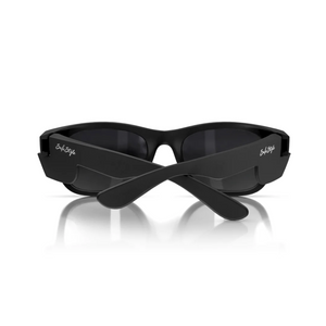 The SafeStyle Classics feature matte black frames with polarised oval lenses and a reflective surface, laid on a white background. The crossed arms display logos near the hinges, offering UV protection for optimal safety.