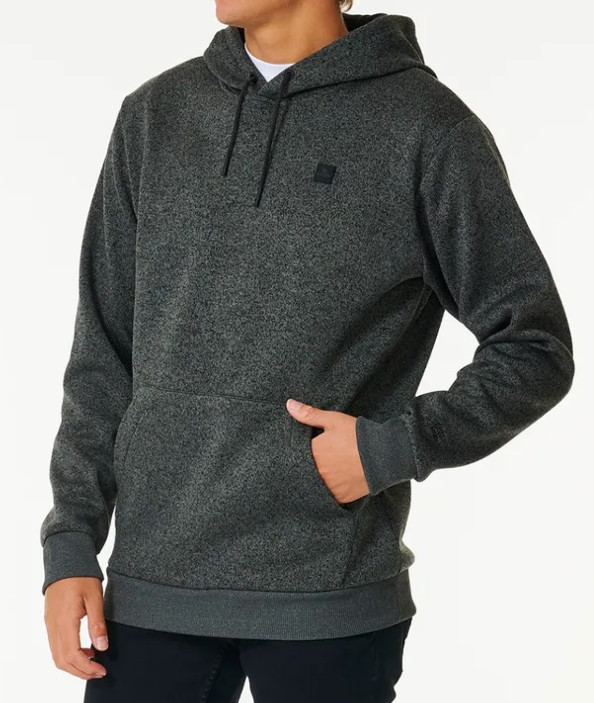 A person wearing a dark gray Rip Curl Anti Series Crescent Hood sweatshirt with a front pocket and drawstrings stands against a plain light background, one hand in the pocket and the other by their side.
