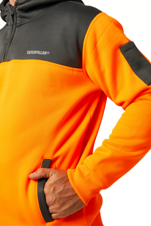 A person wears the CAT Hi Vis Hoodie in bright orange and gray, with a hand in the pocket, highlighting its rugged dependability, warm fleece lining, unique design features, and bold CAT logo on the chest.