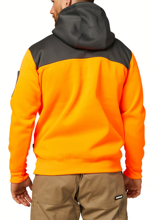 A man wears a high-visibility orange and dark gray CAT Hi Vis Hoodie, featuring a cozy fleece lining and large hood, stands with his back to the camera. He pairs it with khaki work pants, hands by his sides.