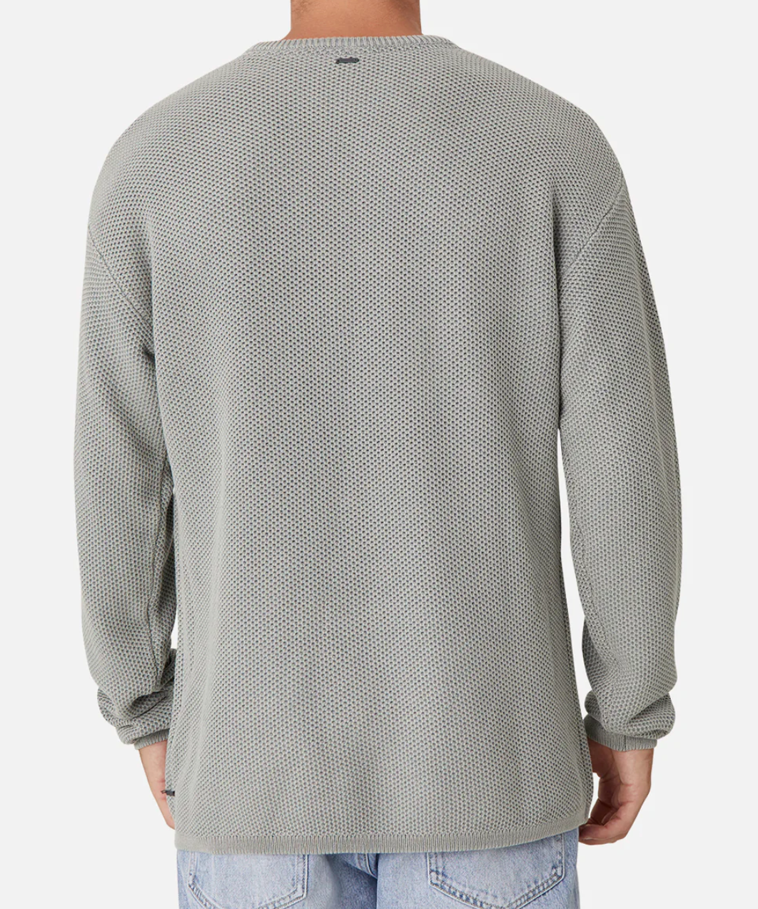 Seen from the back, a person is wearing a gray Industrie The Washed Culver Knit long-sleeve shirt with a waffle texture and relaxed fit, made from 100% cotton. It pairs effortlessly with light blue jeans against a plain white background.