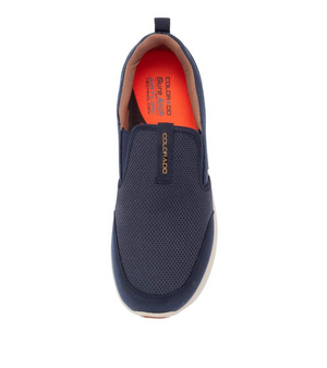 A top-view image of the Colorado Saka Casual Shoe in navy blue, featuring a breathable mesh upper. The orange insole, labeled "Colorado Super Flex Comfort," provides cushioning. The shoe includes a white sole with a cushioned phylon midsole and bears a dark navy band over the instep showcasing the brand name "Colorado.