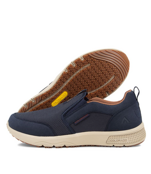 A pair of blue Colorado Saka Casual Shoes with beige outsoles. One shoe is displayed upright while the other is laid on its side, revealing the tread pattern and cushioned phylon midsole offering excellent arch support. The shoes feature a loop on the back and subtle branding near the heel and tongue.