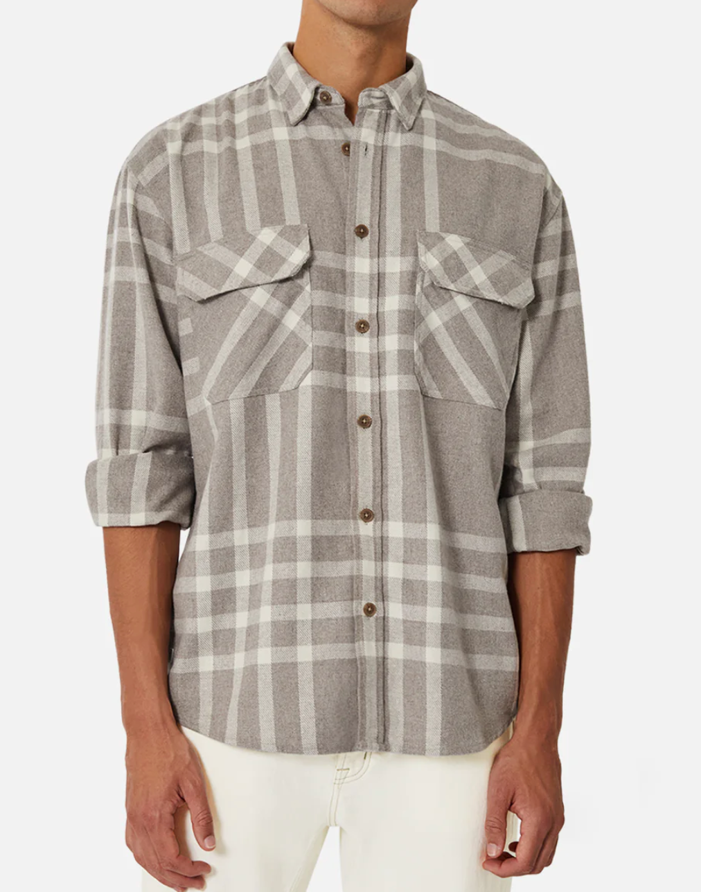 A person is wearing the Industrie The Branford Shirt, a stylish gray plaid button-up with a regular fit, featuring two front pockets and brown buttons. Their long sleeves are rolled up, complementing white pants on a plain white background.