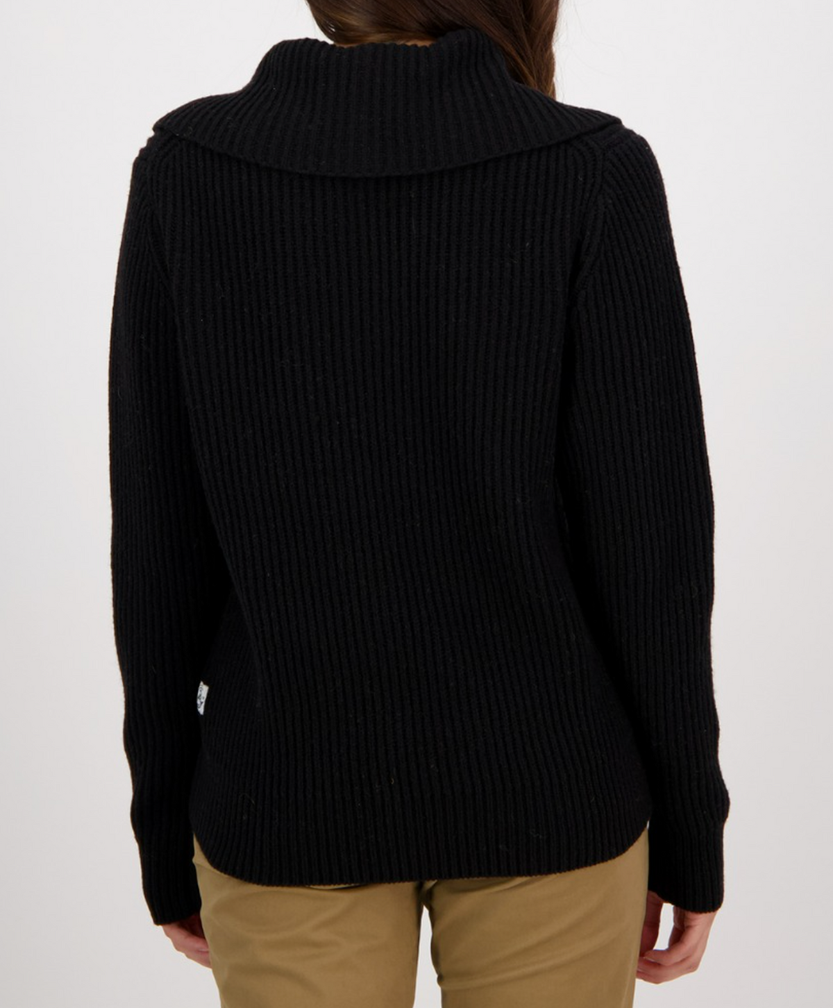 Someone wearing the Swanndri Riverside Zip Neck Rib Jumper in black, featuring a wide collar and ribbed lambswool, is shown from the back with tan pants against a plain white background.
