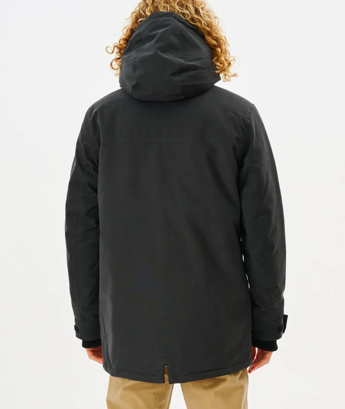 Seen from behind, a person with curly hair wears the Rip Curl Anti Series Exit Jacket featuring Durable Water Resistant technology and khaki pants, perfect for winter. They stand against a plain white background.