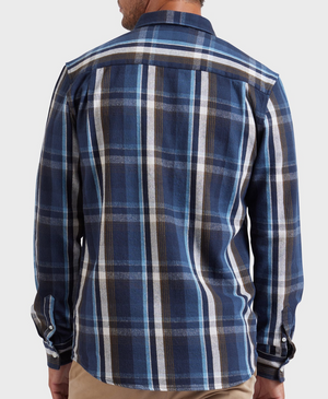 A person is shown from the back wearing an Academy Brand So Cal Shirt, a long-sleeved blue plaid shirt with white, black, and brown stripes made from 100% cotton, paired with beige pants against a plain light background.