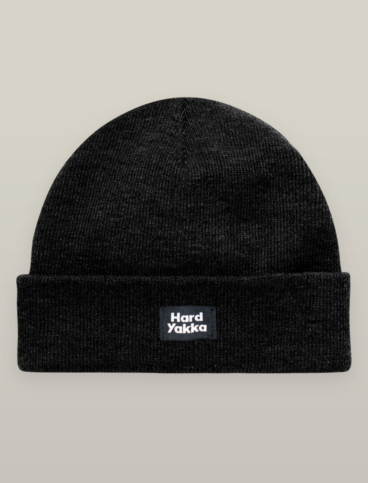 A black knit beanie with a folded brim and "Hard Yakka" logo patch, ideal to pair with the Hard Yakka Sherpa Bonded Fleece Jacket, displayed on a neutral background.