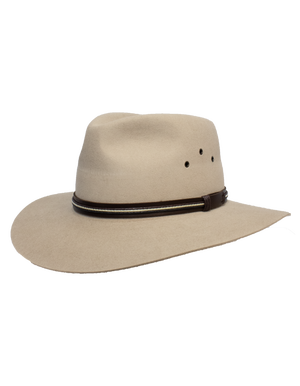 The Sovereign Cattleman is a beige wide-brimmed hat crafted from rabbit fur felt, featuring a brown leather band and crown ventilation holes, displayed against a plain white background.
