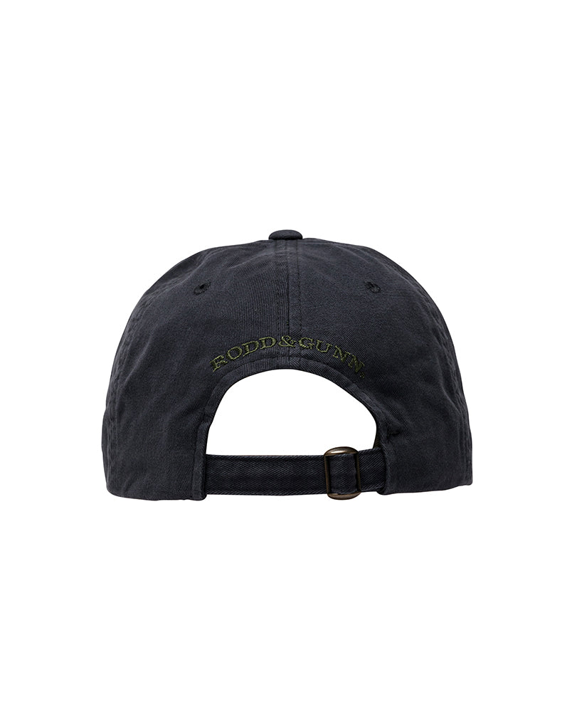 Back view of the Rodd & Gunn Signature Cap, featuring a black cotton twill material and a metal buckle adjustment strap. The text "RODD & GUNN" is embroidered in yellow thread above the opening of this distinctive cap.
