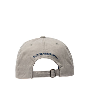 The Rodd & Gunn Signature Cap, in gray cotton twill, is shown from the back with an adjustable strap and metal buckle. "RODD & GUNN" is embroidered in navy blue thread above the opening.