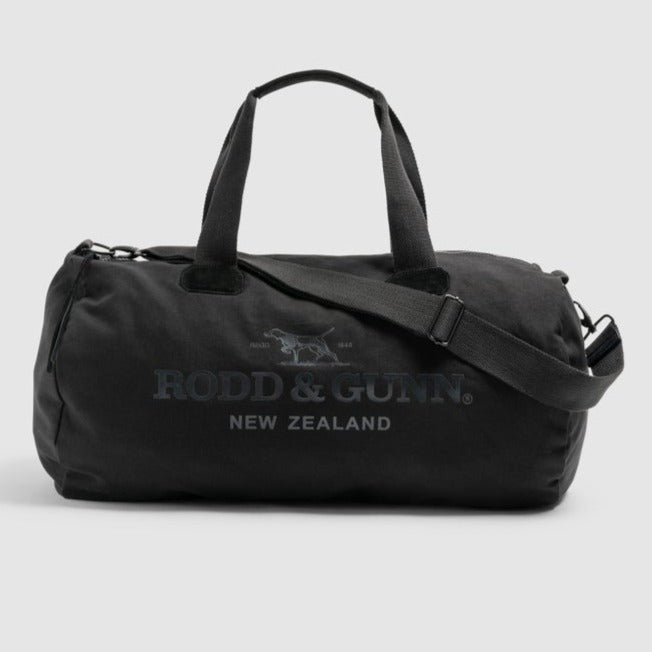The Rodd & Gunn Richmond Road Duffle Bag, made from durable cotton canvas, displays the "Rodd & Gunn New Zealand" logo. It includes both carrying handles and an adjustable shoulder strap, shown against a plain light gray background.