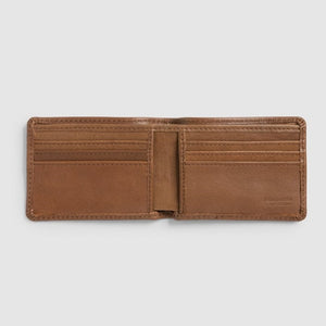 The Rodd & Gunn Victoria Flats Road Wallet, made from buffalo leather in open brown, offers multiple inviting card slots. Its minimalist design stands out against a plain gray background, highlighting its rugged elegance and ready-for-anything charm.