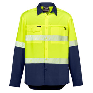 The Syzmik Hi Vis Light Weight Segmented Tape Shirt is a high-visibility, lightweight work shirt with a yellow upper body and segmented taping for added safety. The lower part and sleeves are made of navy blue polyester ripstop material. It also features a front pocket on the left chest with a pen holder slot and a name tag above the pocket.