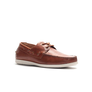 The Rodd & Gunn Gordons Bay Boat Shoe, crafted from brown leather, features white stitching and a rubber outsole. It showcases side eyelets with laces threaded through them. The leather upper is angled to highlight its side and top views.