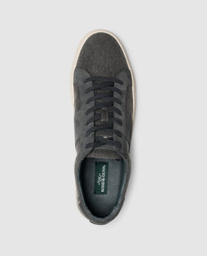 Top view of the Rodd & Gunn Endeavour Sail Sneaker—a single dark gray sneaker featuring suede leather trims and matching dark gray laces, set against a plain light gray background. The sneaker boasts a white sole and a moulded footbed for enhanced comfort, with the inner sole showcasing a green label reading "Rodd & Gunn.